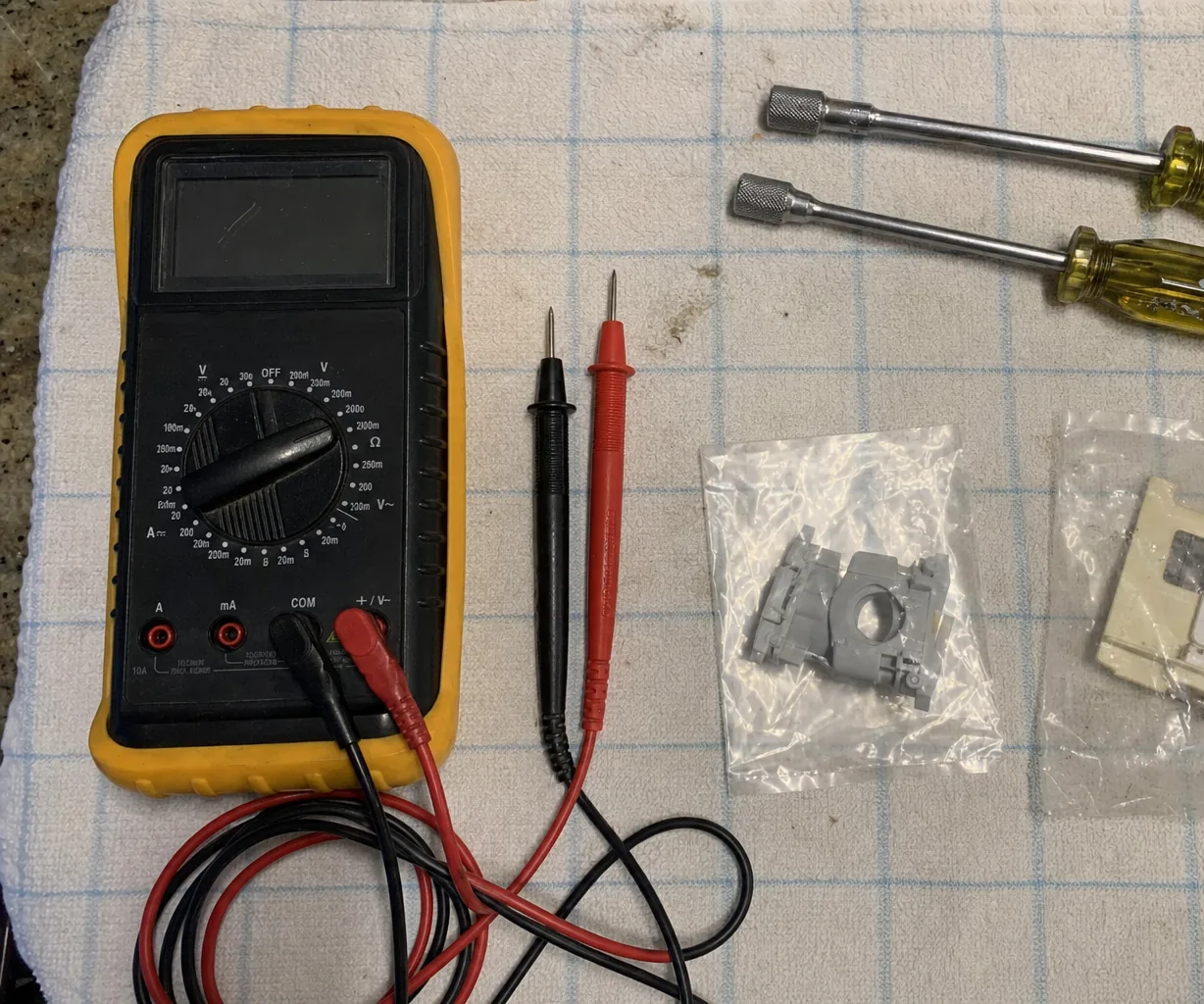 A commercial repair technician's tools laid out during a 24/7 emergency visit